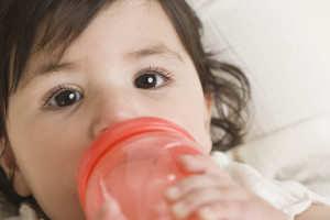 Hispanic baby drinking from bottle